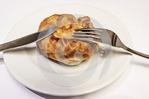 Ready to eat turkish rose pastry borekwith white cheese in white plate with spoon and fork