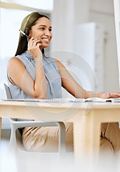 Ready to help, happy call center agent selling insurance helping a customer or client via her headset at help desk