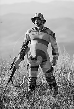 Ready to shoot. Army forces. Man military clothes with weapon. Focus and concentration experienced hunter. Brutal