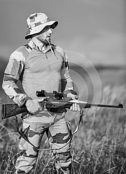 Ready to shoot. Focus and concentration experienced hunter. Hunter hold rifle. Hunter mountains landscape background