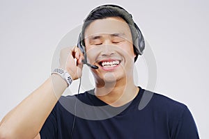 Ready to take your call. Studio shot of a handsome young male customer service representative wearing a headset against