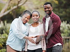 Ready to welcome new life. a couple celebrating a pregnancy with their mother in law.