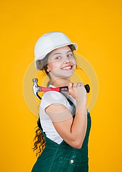 Ready to work. building and repair tools. repairman. small girl repairing in workshop. cheerful kid in helmet hold