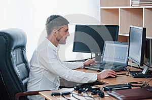 Ready to work. Polygraph examiner works in the office with his lie detector`s equipment