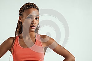 Ready for workout. Close up of beautiful young african woman in sports wear looking at camera while standing against