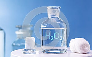 Reagent bottle with glass stopper, with hydrogen peroxide inside. Chemical element H2 O2 in laboratory photo