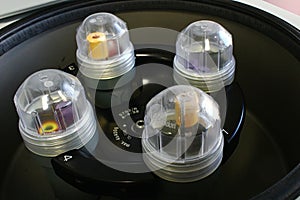 Reagent test tubes and covers placed on rotor of benchtop centrifuge