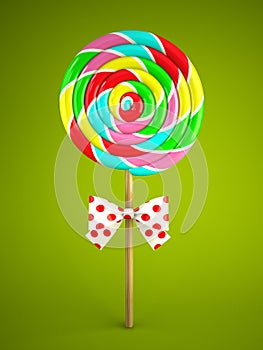Reainbow lollipop with bow on green background