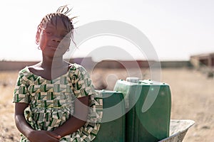 Real African Girl with nutritiousWater for a lack of water symbol photo