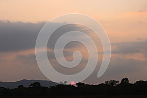 Real amazing panoramic sunrise or sunset sky with gentle colorful clouds. Sunset Sunrise Sundown Sky