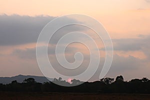 Real amazing panoramic sunrise or sunset sky with gentle colorful clouds. Sunset Sunrise Sundown Sky