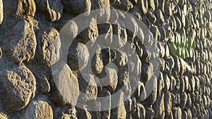 Real backround with grey crushed stones and sunbeam. Old brick wall in a summer day. Copy space