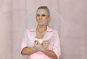 Real Beauty Specialist Holds Tools For Mesotherapy Injection, Dermapen, Face Serum on Pink photo