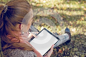 Real businesswoman with tablet laptop at work outdoors in park