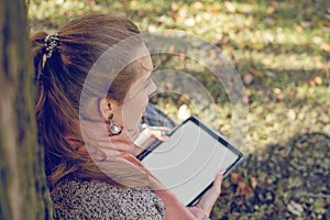 Real businesswoman with tablet laptop at work outdoors in park