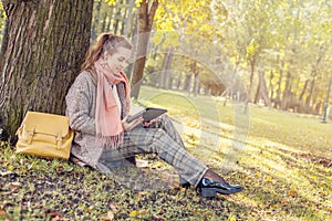 Real businesswoman with tablet laptop at work outdoors in park