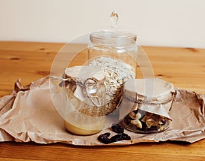 Real comfort wooden kitchen with breakfast ingredients close up in glass, honey, oatmeal, milk, muesli, morning food