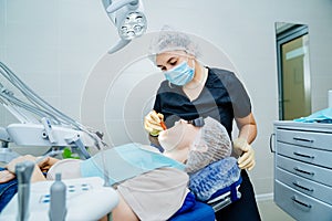 real. dentist examines patient& x27;s teeth. regular care and prevention.