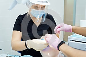 real. dentist prepares for treatment of patient's teeth