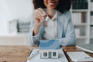 Real estate agent, African American businesswoman Africans use smartphone and calculators to offer mortgages to their