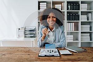 Real estate agent, African American businesswoman Africans use smartphone and calculators to offer mortgages to their