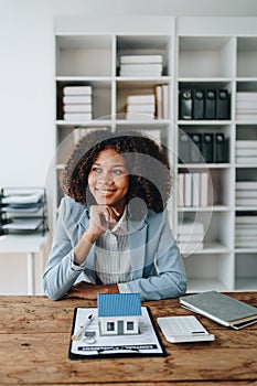 Real estate agent, African American businesswoman Africans use smartphone and calculators to offer mortgages to their