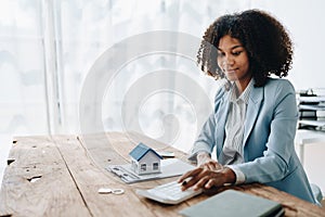 Real estate agent, African American businesswoman Africans use smartphone and calculators to offer mortgages to their