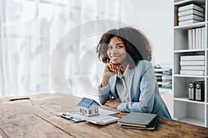 Real estate agent, African American businesswoman Africans use smartphone and calculators to offer mortgages to their