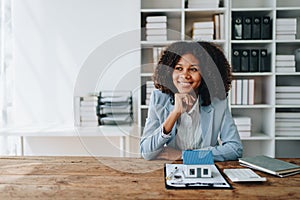 Real estate agent, African American businesswoman Africans use smartphone and calculators to offer mortgages to their