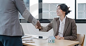 Real estate agent African American handshake to customer business woman asian to congratulate after sign a contract to