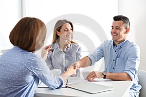 Real estate agent consulting young couple