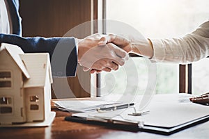 Real estate agent and customers shaking hands together celebrating finished contract after about home insurance and investment lo