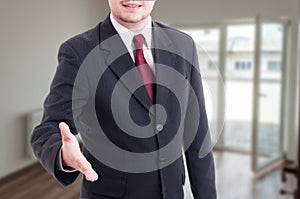 Real estate agent doing welcoming gesture