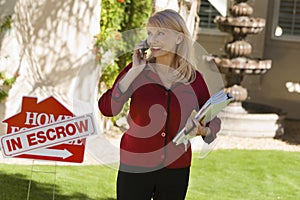 Real Estate Agent With Files Answering Mobilephone