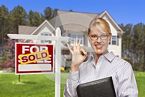 Real Estate Agent in Front of Sold Sign and House