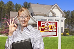 Real Estate Agent in Front of Sold Sign and House