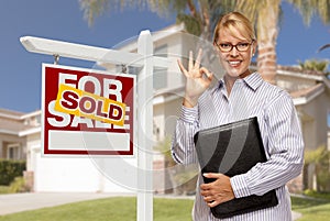 Real Estate Agent in Front of Sold Sign and House