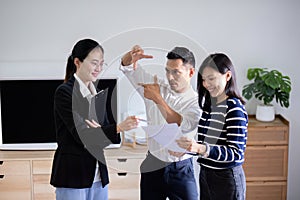 Real estate agent giving buy or tenant tour about big new house. Couple or husband and wife who plan property investment