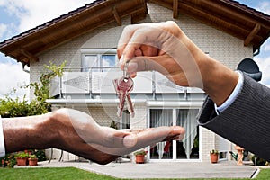 Real Estate Agent Giving House Key To Client