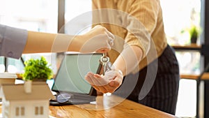 Real estate agent giving a house key to new landlord