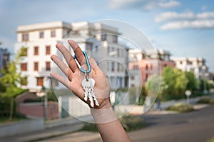 Real estate agent giving house keys to a new property owner