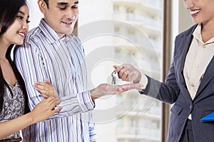 Real estate agent giving a key