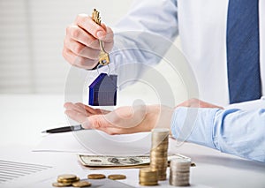 Real estate agent giving keys to the customer over the table