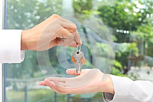 Real estate agent giving keys to woman