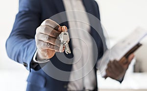 Real estate agent handing the house key