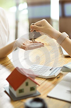 Real estate agent handing over a house key to a new tenant