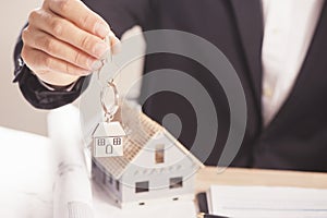 Real estate agent handing over house keys.