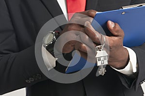 Real estate agent handing over house keys.