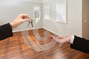 Real Estate Agent Hands Over New House Keys Inside Empty Room