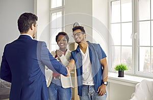 Real estate agent handshake couple buyers